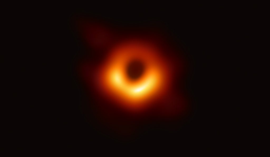 Primera imagen jamás obtenida de un agujero negro. El agujero negro, en el centro de la galaxia M87, está perfilado por la emisión de gas caliente girando a su alrededor bajo la influencia de una fuerte gravedad cerca de su horizonte de sucesos. La imagen fue tomada por el Event Horizon Telescope. Créditos: Event Horizon Telescope Collaboration